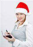woman with a notebook in a Christmas hat