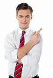 Smart businessperson pointing away from camera