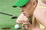 girl's playing with golf ball, she is in profile