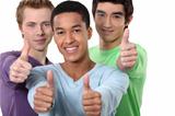 Three male friends giving thumbs-up