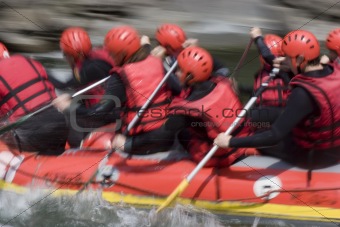 Red rafting team on whitewater