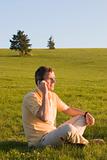 Man with cell phone in a meadow
