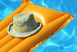 hat on yellow airbed