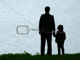 Man and child silhouette at evening