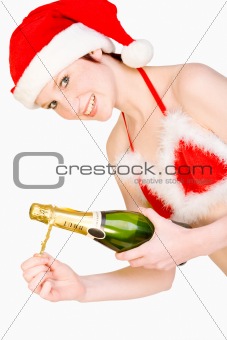 Christmas girl is holding a bottle of champagne
