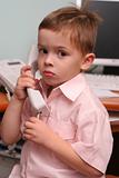 The boy speaks by phone in working hours