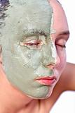 Relaxing with green clay on face