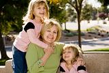 Twin Girls With Grandmother Laughing In The Park