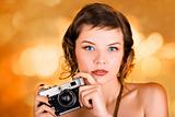 glamorous girl holding a camera