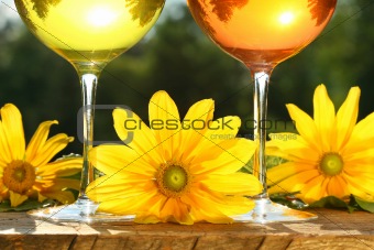 Golden wine in the sun on a rustic table