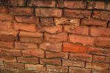 much eroded brick wall