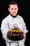 Handsome chef with cake