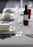 Table setting with plates and wine glasses