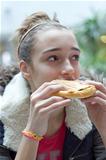 Teenage girl eating sandwich