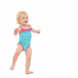 Smiling baby in swimsuit dancing