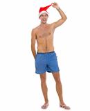 Full length portrait of on vacation man in shorts and Santa's hat