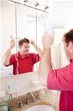 Man Blow Drying Hair in Bathroom