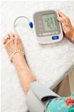 Senior Woman Taking Blood Pressure