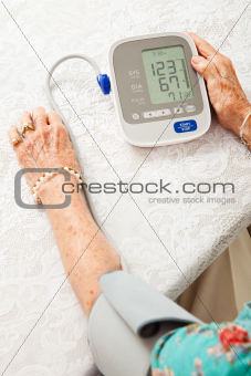 Senior Woman Taking Blood Pressure