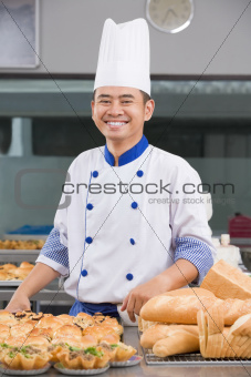 Chef or baker posing in front of the pastries