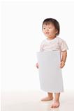 Asian female toddler holding white paper