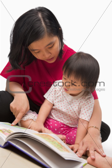 Mother teaching her little girl