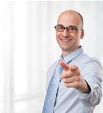 smiling young businessman pointing finger at camera