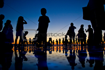 People reflections on colorful sunset