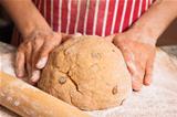 Hands kneeding a dough