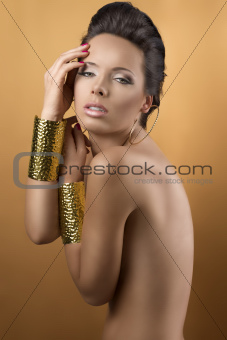 sexy brunette with two golden bracelets, with sensual expression