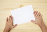 human hand holds a blank paper