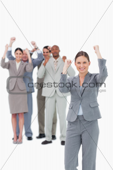 Cheering saleswoman with team behind her