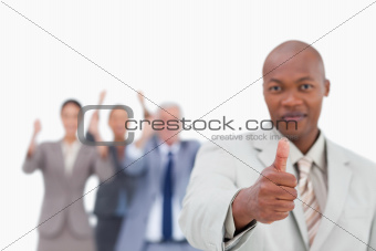 Salesman with team behind him giving approval