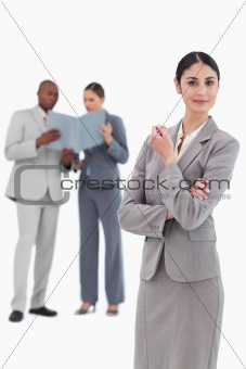 Saleswoman with co-workers behind her