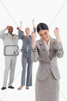 Successful businesswoman with cheering associates behind her