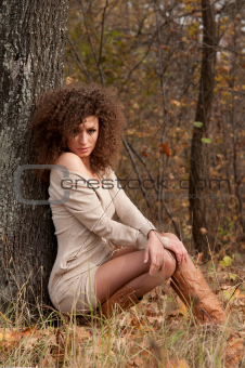 woman sitting near a tree