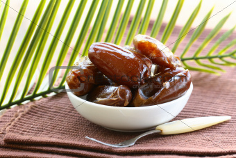 sweet dates in  bowl on a natural background