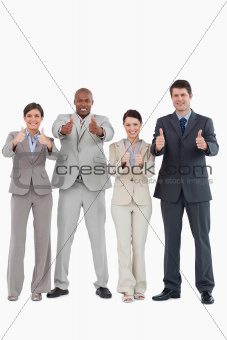 Businessteam giving thumbs up together