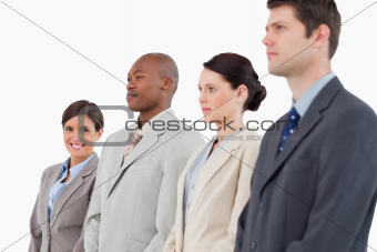 Smiling businesswoman standing next to her colleagues
