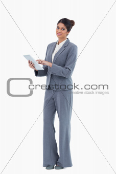 Smiling saleswoman using tablet