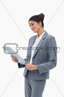 Smiling businesswoman looking at clipboard