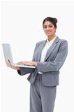 Smiling businesswoman using notebook while standing