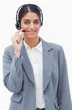 Smiling call center agent adjusting microphone