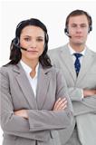 Call center agents with headsets and arms folded