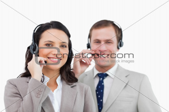 Smiling call center team with their headsets