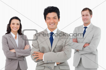 Smiling salesteam with arms folded