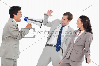 Businessman with megaphone yelling at colleagues