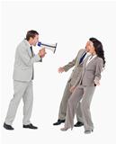 Businessman with megaphone yelling at associates