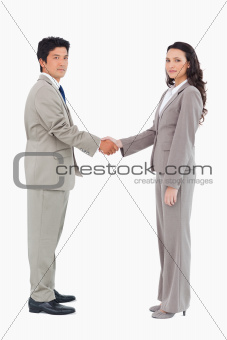 Side view of trading partners shaking hands