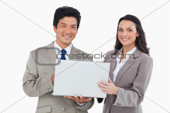 Smiling salesteam with laptop